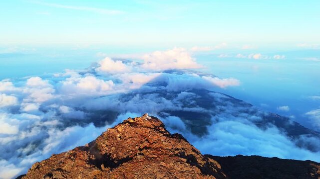 Piquinho, Top of Mount Pico Stratovolcano, Crater and Clouds at Sunset. Shadow of Mountain. Atlantic Ocean. Pico Island, Azores. Portugal. Aerial View. Drone Moves Backwards