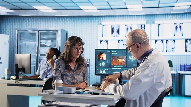 Old physician recommending vitamins and painkillers on medical insurance, writing prescription with instructions and the right dosage of medicine. Healthcare services and pharmaceutics. Camera A.