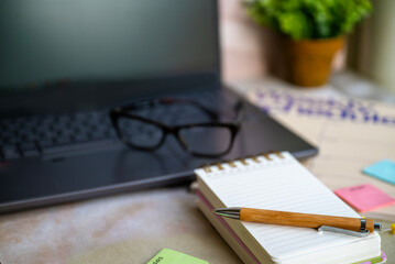 Notebook planner and organizer on a desk with laptop 