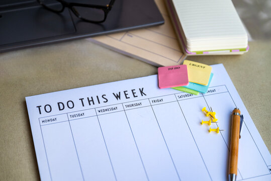 Notebook planner and organizer on a desk with laptop 