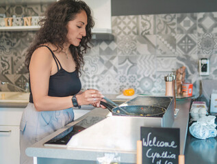 Home cook preparing breakfast. Woman preparing eggs for the family's breakfast.
