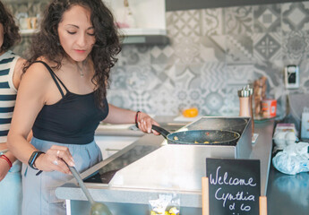 Home cook preparing breakfast. Woman preparing eggs for the family's breakfast.