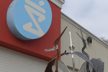 Fototapeta premium Shoppers Drug Mart logo sign outside location at 550 Eglinton Av W (with detail of Gathering by Mark Puigmarti), Toronto