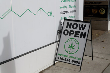 Fototapeta premium sidewalk sign outside THE POT SPOT, a cannabis store, located at 1860B Eglinton Av W, Toronto