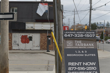 Fototapeta premium sidewalk sign near The Fairbank, an apartment complex, located at 9 Croham Rd, Toronto (photo: looking east on Eglinton Av W)