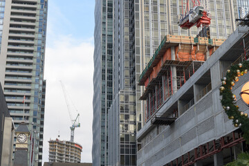 Fototapeta premium looking east on Yorkville Av to new construction site and clock tower at fire station 312, Toronto