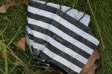 Fototapeta premium grungy, discarded Sephora bag on the ground, Toronto