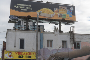 Fototapeta premium rooftop billboard for Armstrong cheese above Wing Machine located at 1661 Eglinton Av W, Toronto