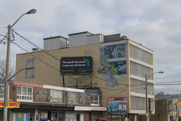 Fototapeta premium wide view of a rooftop billboard for Desjardin Financial on Eglinton Av W (Ajmer Dollar Discount), Toronto