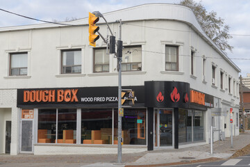 Fototapeta premium exterior building facade and sign of DoughBox Wood Fired Pizza & Pasta, a pizza restaurant, located at 1466 Eglinton Ave W, Toronto