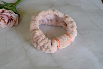 Pink terry cloth headband for beauty and self-care