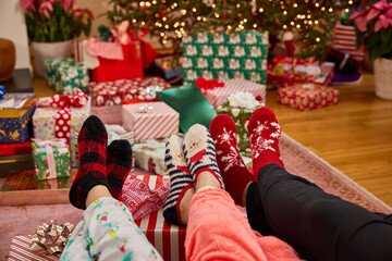 Cozy holiday vibes with festive socks and gifts under the christmas tree
