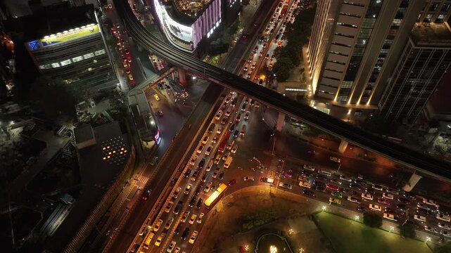 night time illuminated bangkok city downtown flight over famous traffic street crossroad aerial panorama 4k thailand 