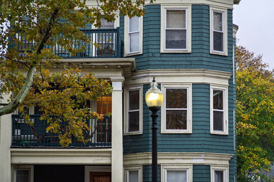 The unique teal exterior and classical architecture of a Brighton apartment building in autumn, Massachusetts, USA
