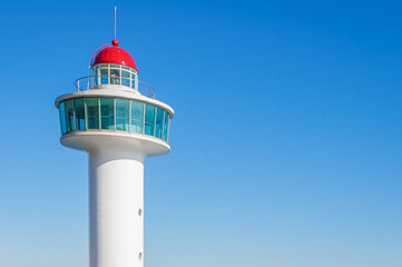 White Coastal Lighthouse Tower Under Clear Blue Sky