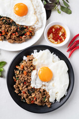 Thai food, Stir fried holy basil with minced pork with cooked rice and fried egg on top, Top view