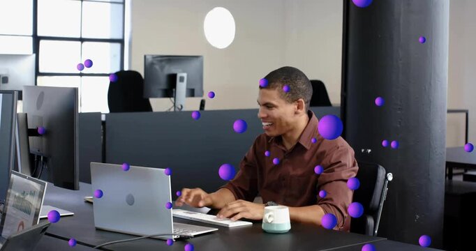 Tech pro typing celebrating win calling peer and pointing laptop as purple orbs floating over desk