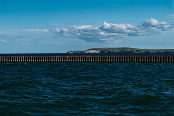 Harbor and boat club entrance to the Sodus Point Bay with the Chimney Cliffs in the background and the iron breakwater