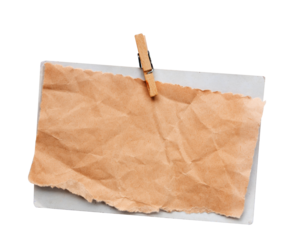 old paper hanging with wooden clothes pin on white background isolated