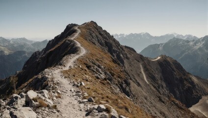 A winding hiking trail crests a rugged mountain ridge with a stunning panoramic vista