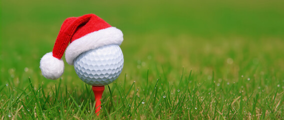 golf ball on green grass, with santa hat