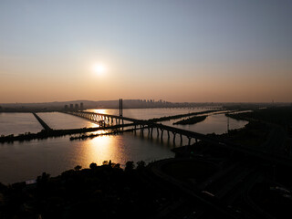 Fototapeta premium Cable stayed bridge over St Lawrence River at golden sunrise near Montreal and Brossard, Canada. g.