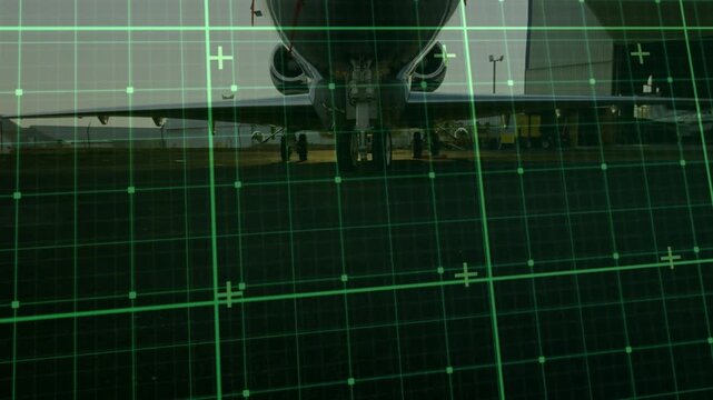 Green grid overlay appearing, jet nose entering frame while crew servicing plane for departure