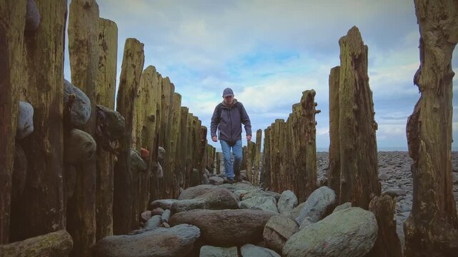 A hiker rambler tourist enjoys the delights of the North Coast of Devon in England via the South West Coastal Path.