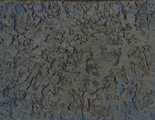 Close-up of a textured dark gray surface with irregular patterns and cracks, resembling natural stone or concrete, creating an abstract rugged background.