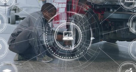 Automotive technician reacting to HUD prompt, kneeling by truck and loosening lug nuts for check - Powered by Adobe