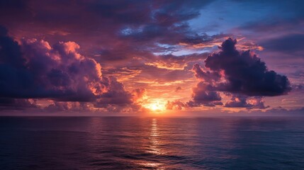 Vibrant sunset over a calm ocean, with dramatic purple and orange clouds reflecting on the water's surface, creating a breathtaking seascape