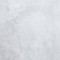 A delicate white ceramic vase adorned with vibrant, blooming flowers in various colors, elegantly placed on a wooden table against a soft, neutral backdrop.