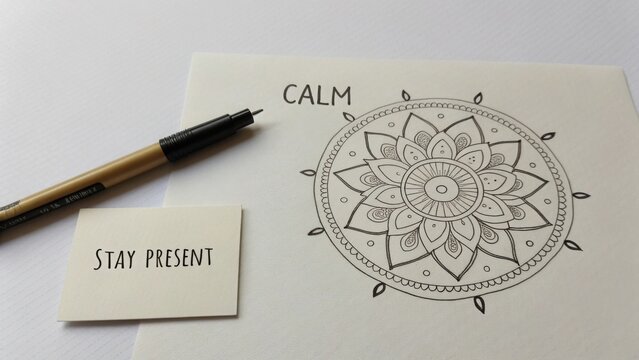 Mandala sketch with pen showing the word calm