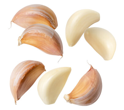close-up photograph of multiple garlic cloves, both raw peeled and unpeeled with skin, dynamically arranged and isolated on a solid transparent background.