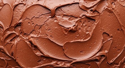 Close up of rich brown chocolate frosting texture on a baked cake