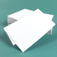 A neat stack of crisp white paper rests on a vibrant green surface, showcasing a clean contrast that highlights the paper's texture and brightness.