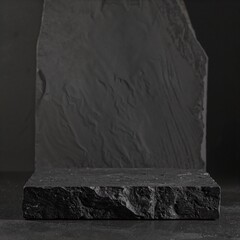 A smooth, weathered stone rests on the ground, surrounded by patches of grass and small pebbles, showcasing earthy tones of gray and brown.