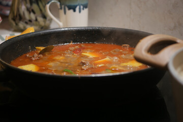 Cooking delicious stew in a pot on a stove