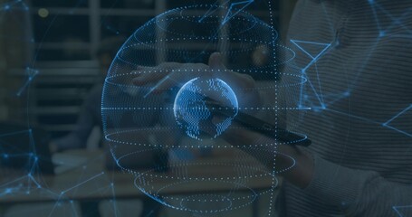 Projecting holographic globe aligning with hands and tablet in office, with staff in ribbed sweater