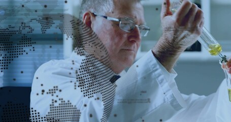 Senior researcher pipetting yellow-green liquid into beaker in lab with lab coat and dotted overlay