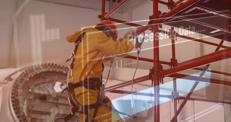 Climbing tech in yellow suit red helmet working on turbine scaffold in hangar with harness overlay