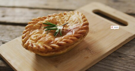 Displaying round pie featuring braided crust and rosemary on cutting board with handle, label icons