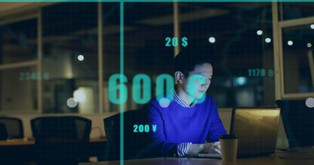 Asian man in blue sweater typing at laptop in conference room with financial graphics, copy space