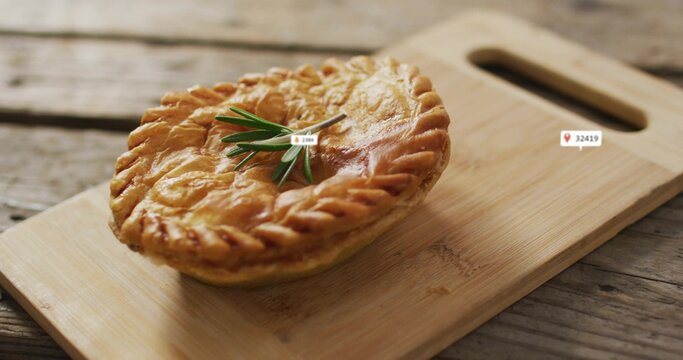 Fototapeta Displaying round pie featuring braided crust and rosemary on cutting board with handle, label icons