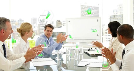 Speaking central male in light-blue shirt gesturing at glass table in office, with green overlays