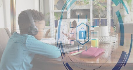 Sitting kid wearing headset watching teacher on laptop at dining table, padlock overlay, copy space