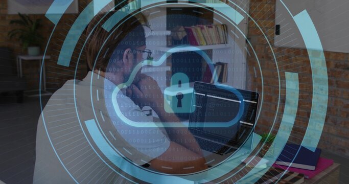 Working mid-adult man wearing glasses typing code on laptop in home office, with cloud lock overlay