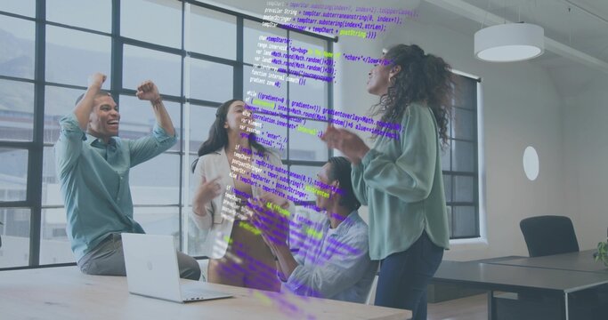 Celebrating team wearing casual attire by conference table near windows, laptop with code overlay - Powered by Adobe