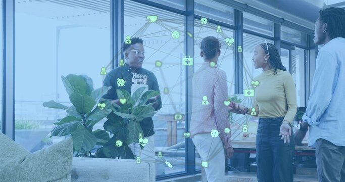 Discussing colleagues wearing casual and smart attire in lounge with fig plant and data overlay