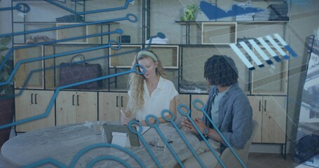 Gesturing male gray-jacket while writing female white-blouse at office table, tablet blue overlay